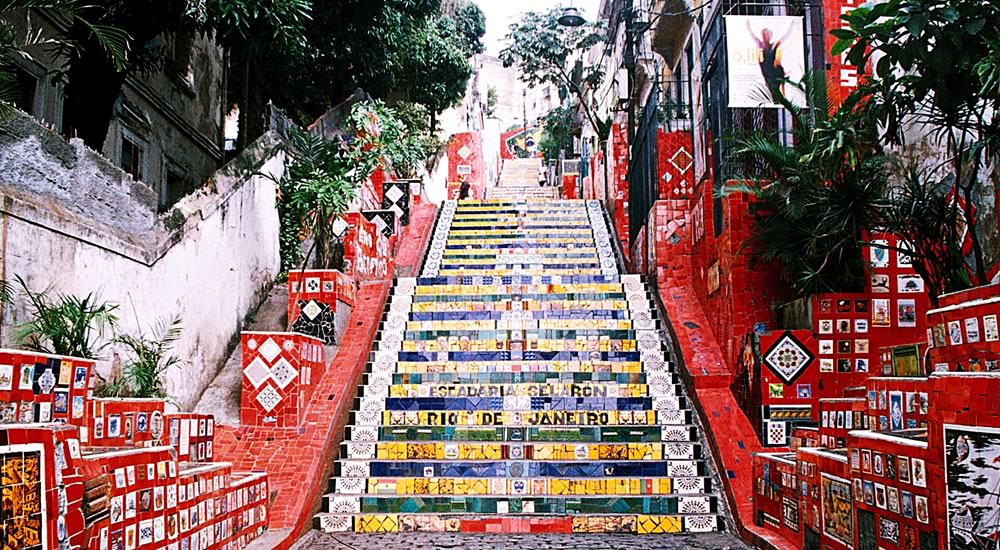 Foto da escadaria Selarón, a escadaria está vaia de pessoas.