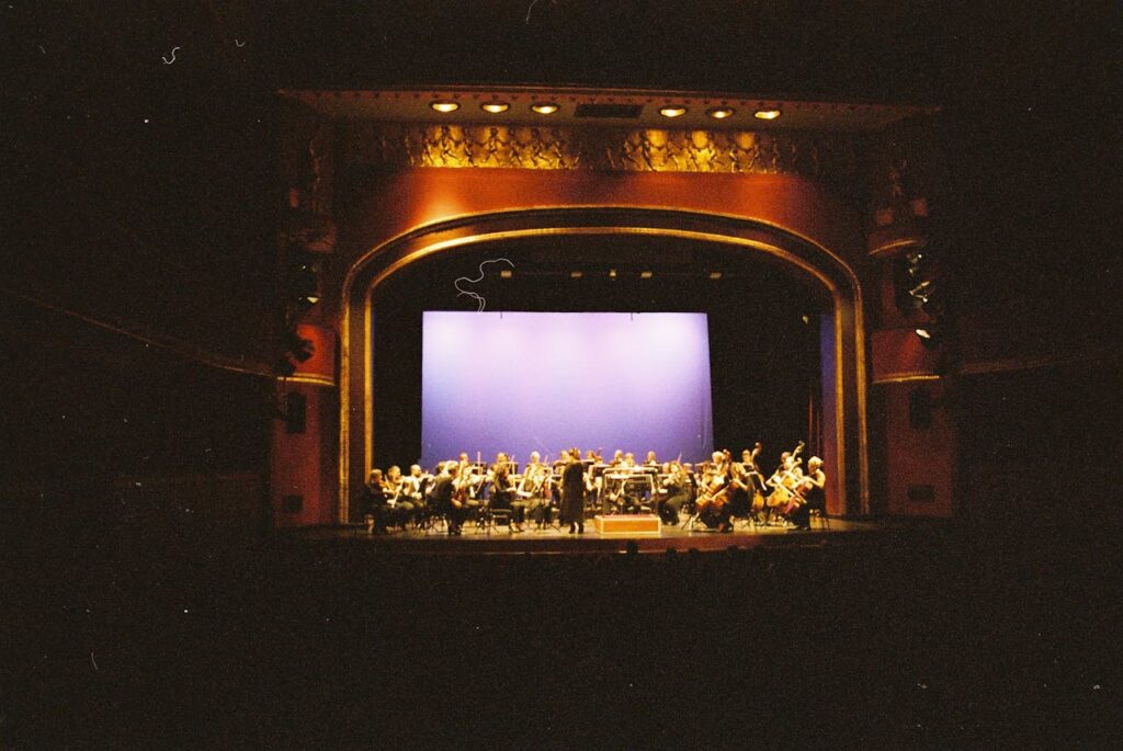 Foto orquestra sinfônica. Apresentação em teatro.